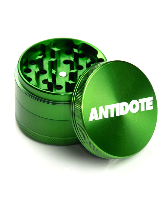 Green Antidote grinder with a kief scrapper included for easy cleaning